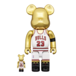 Discover the Hottest Basketball Bearbricks Front view of 400% and 100% Bearbrick Michael Jordan 1991 World Champion edition figures, featuring a gold chrome finish, Chicago Bulls jersey with number 23, NBA logo, and black armband, paying tribute to Jordan’s iconic championship season.