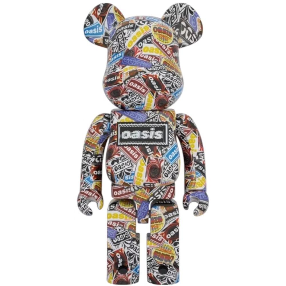 1000% Bearbrick Oasis 2025 covered in colorful collage of Oasis logos, album graphics, and vintage concert-style prints.