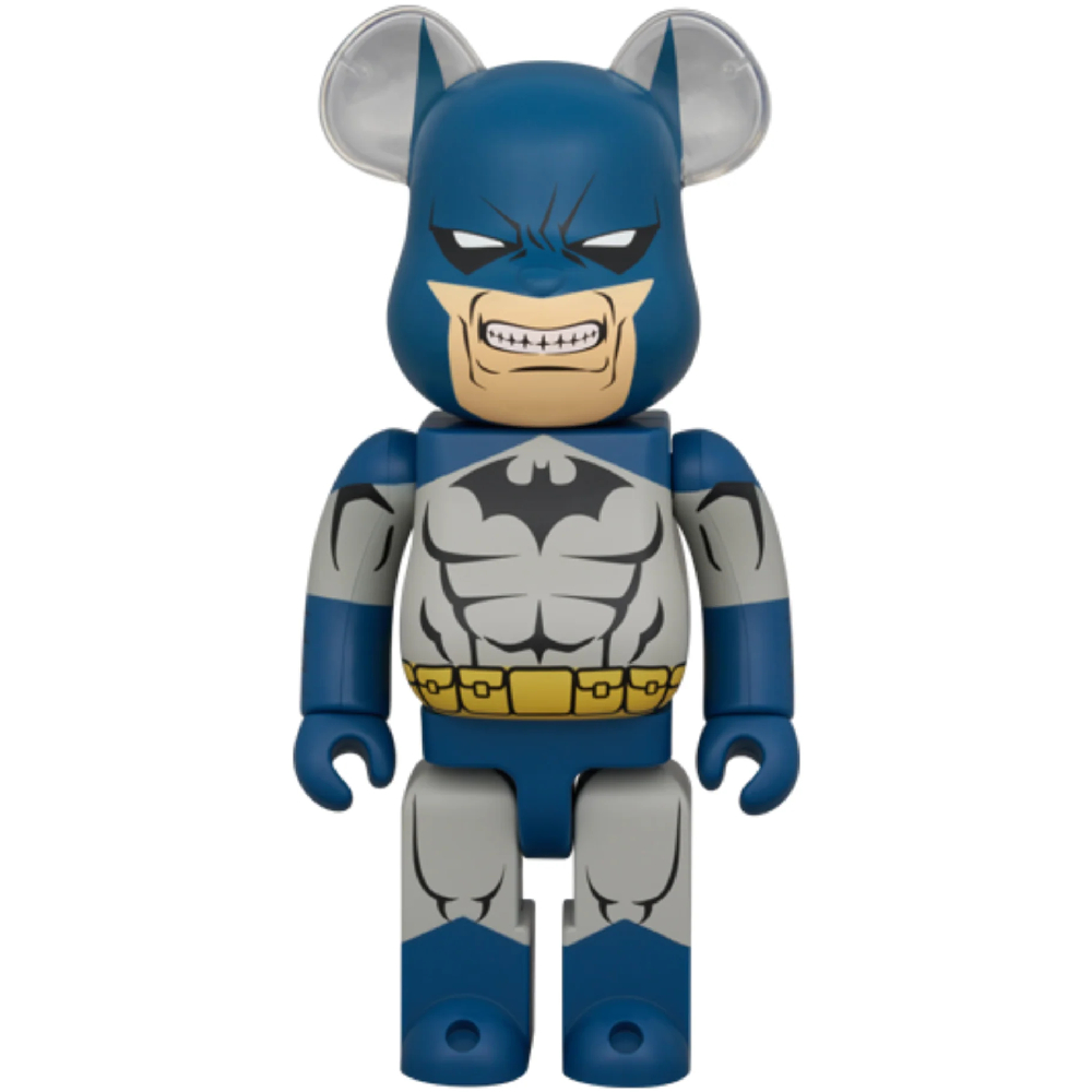 Blue and grey Bearbrick figure in Batman Hush suit with clenched teeth expression, front view.