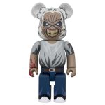 Bearbrick figure with fierce masked face, gray shirt, jeans, and tattooed arm.